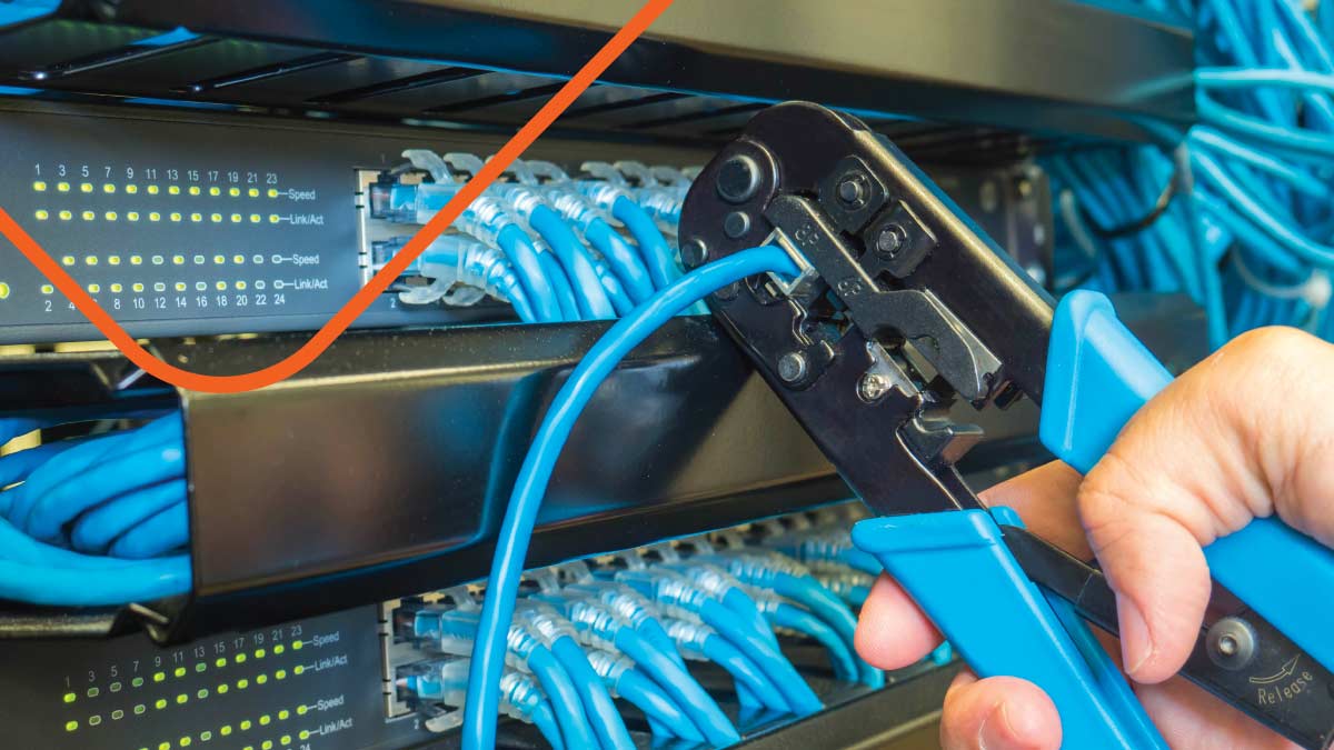 A closeup of person repairing a network cable