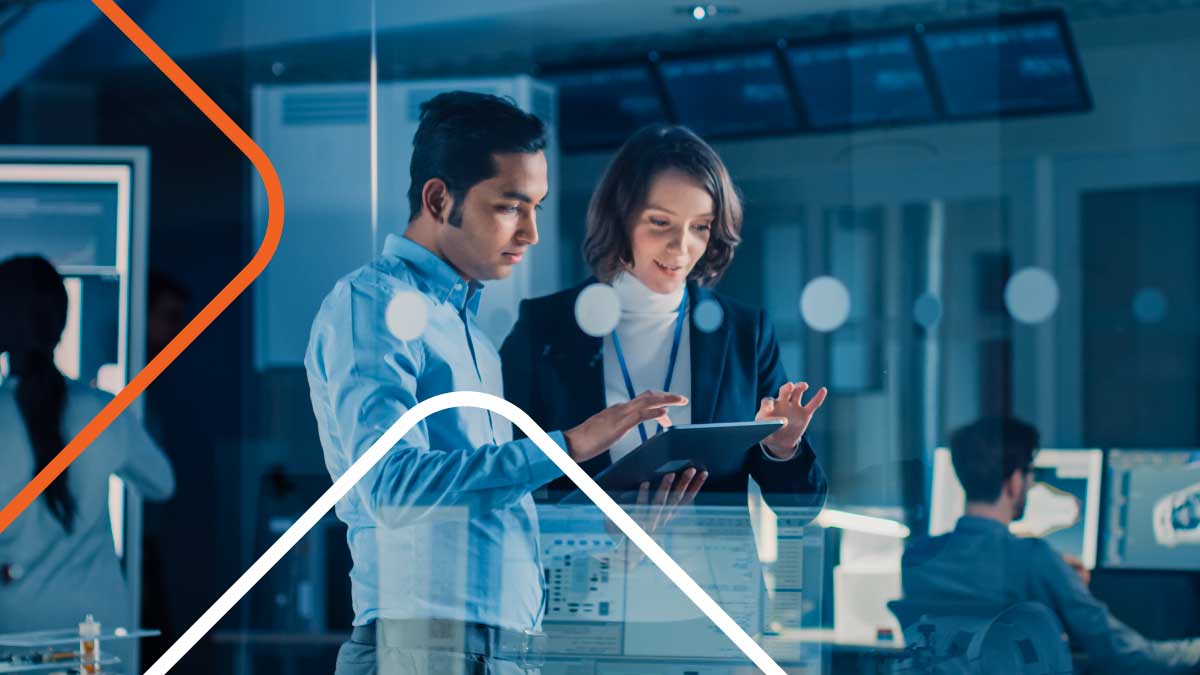 Two colleagues discussing work on a tablet