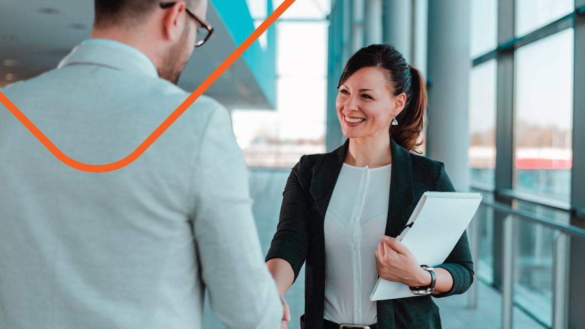 Two people shaking hands in the office